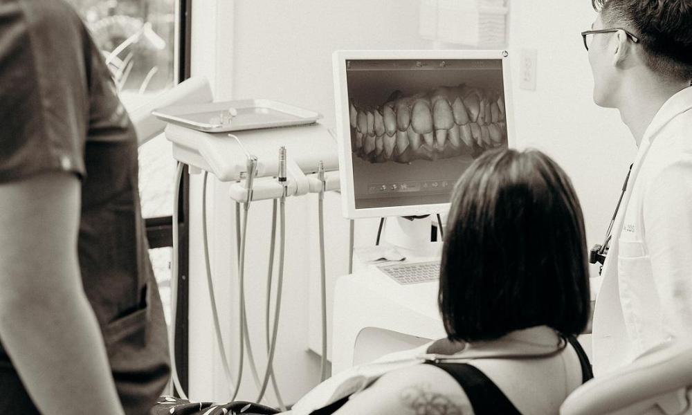 Dr. cho looking at a digital image with patient