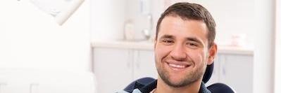 man smiling in dental chair after root canal