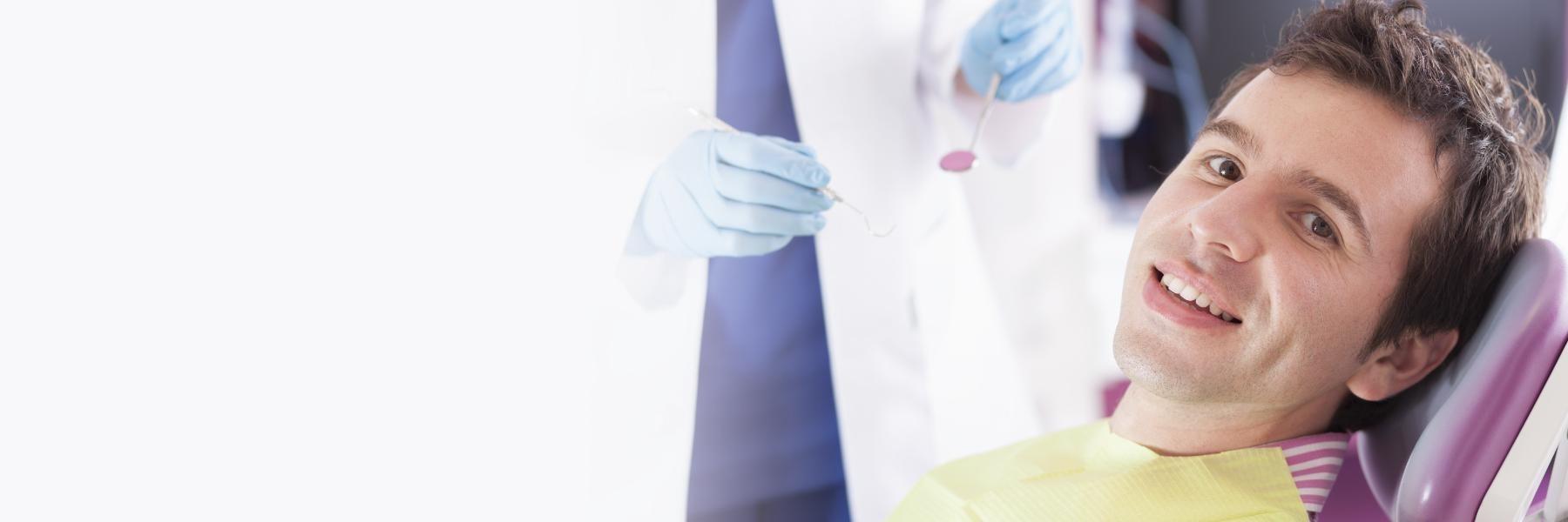 Man sitting in dental chair smiling